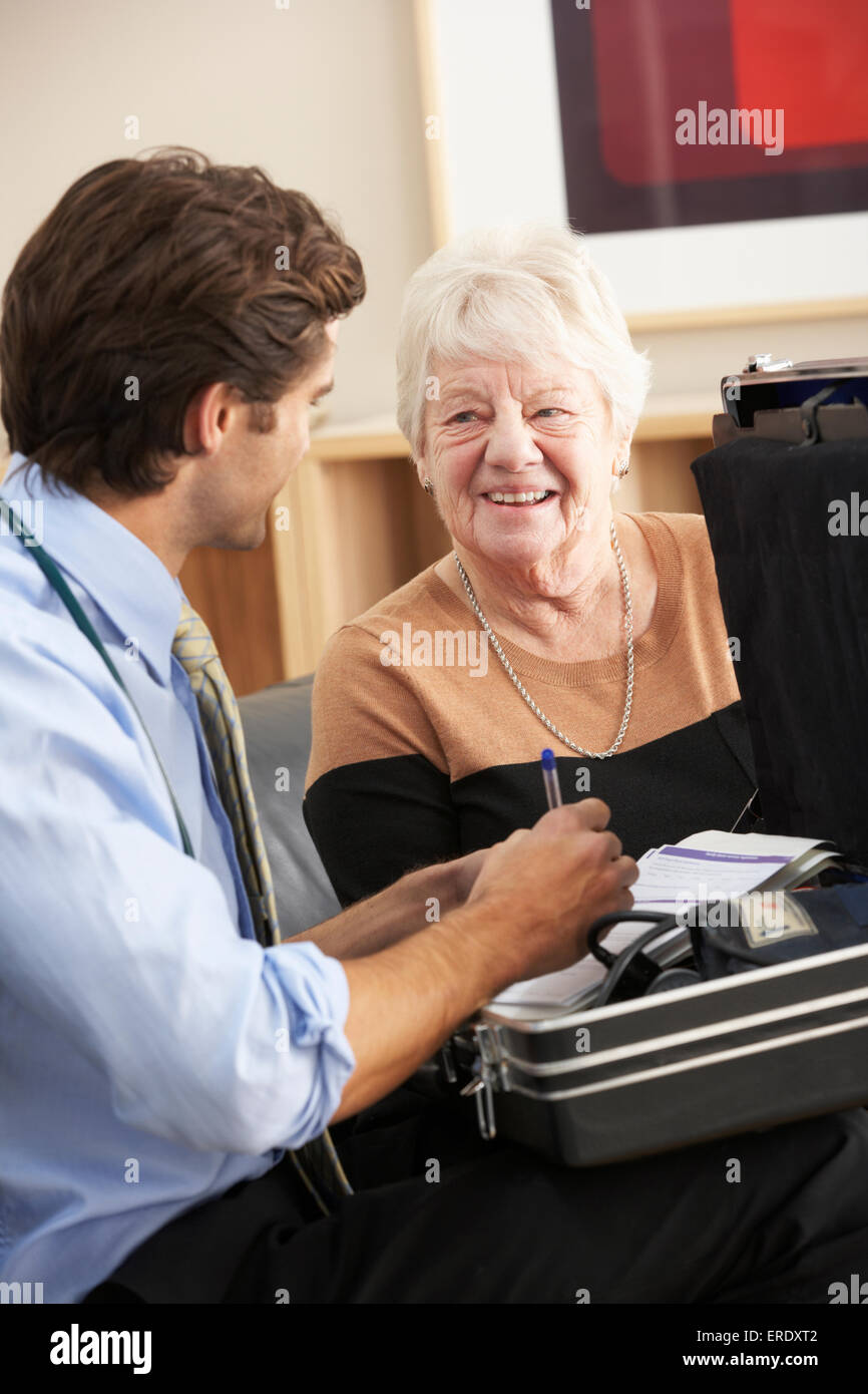 Doctor visiting senior woman at home Stock Photo