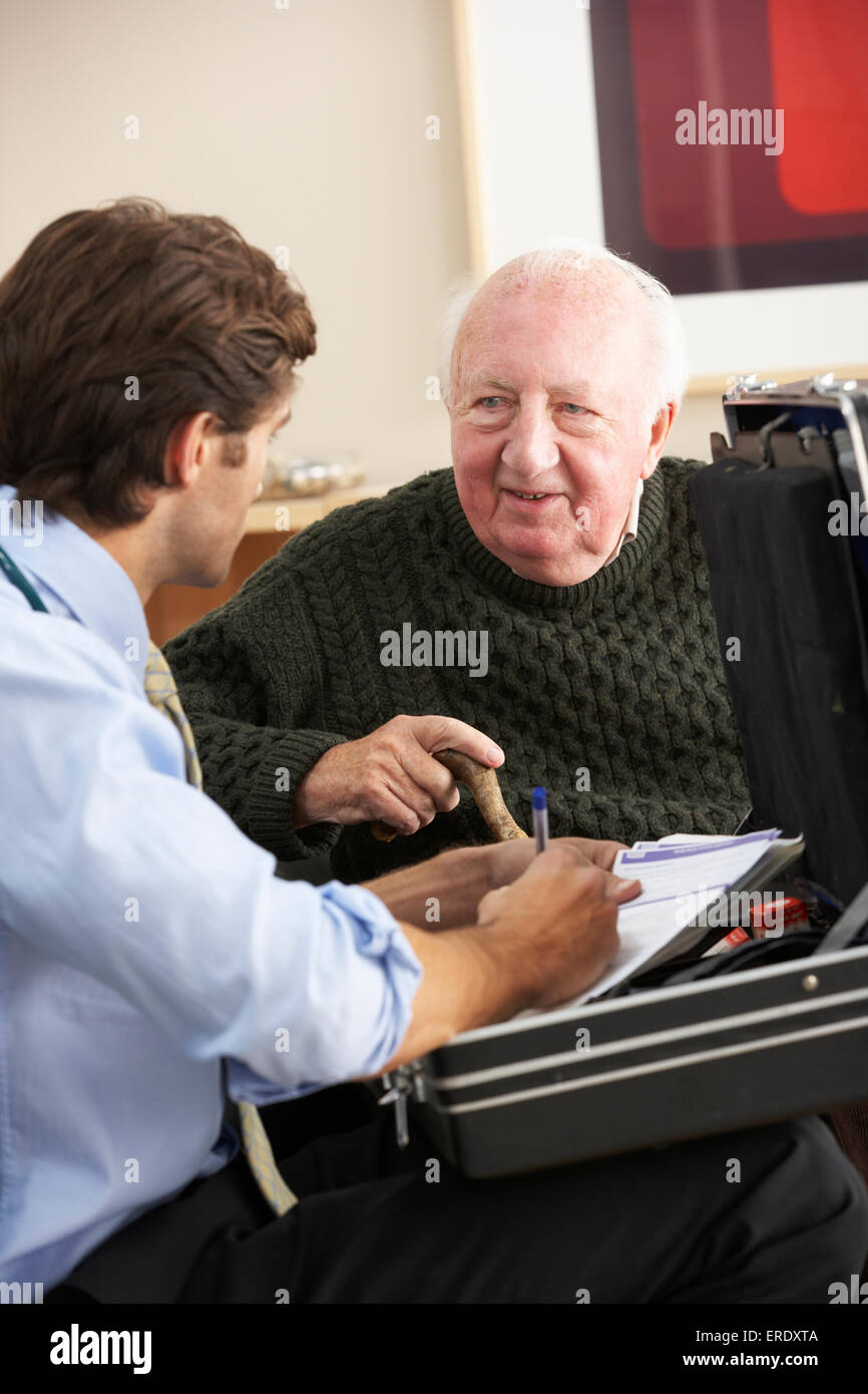 Doctor visiting senior man at home Stock Photo