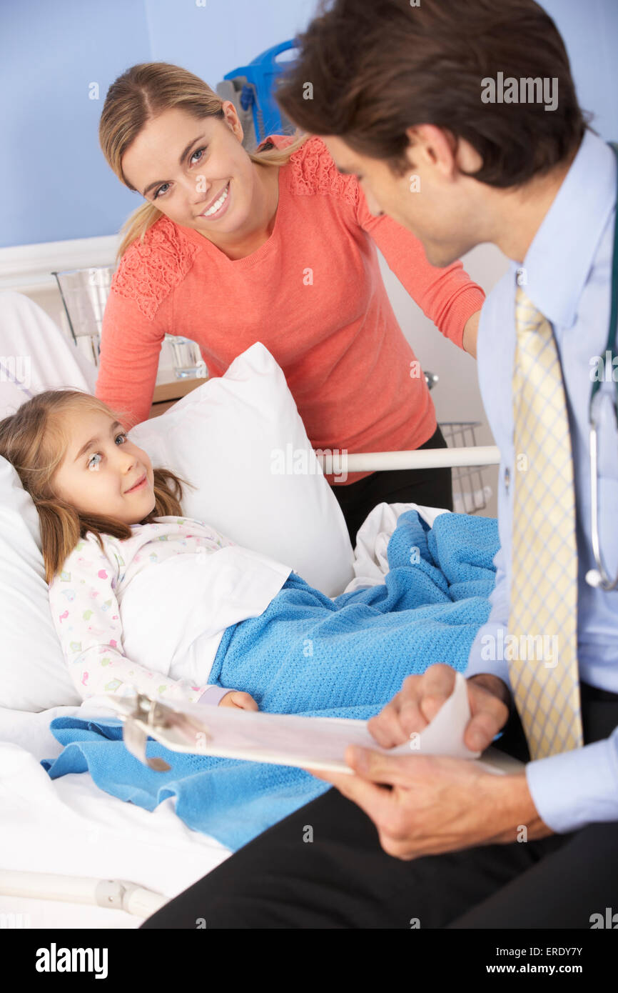 Doctor in hospital with sick girl and mother Stock Photo