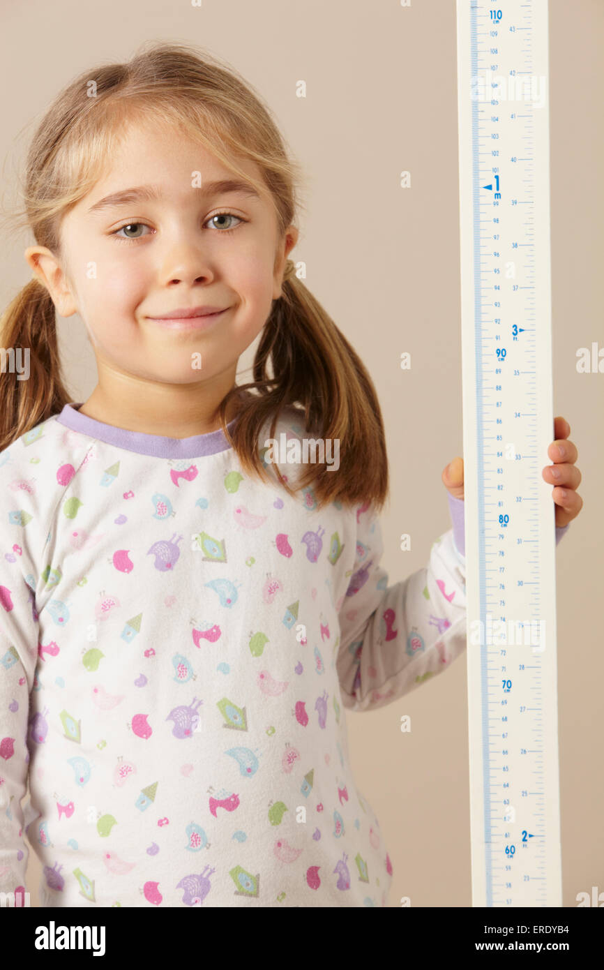 5 year old girl measuring height Stock Photo