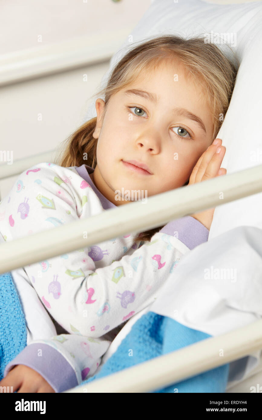 Young girl lying in hospital bed Stock Photo