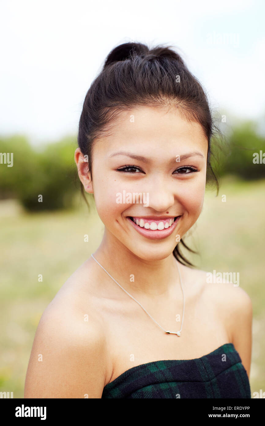 Mixed race teenage girl smiling outdoors Stock Photo