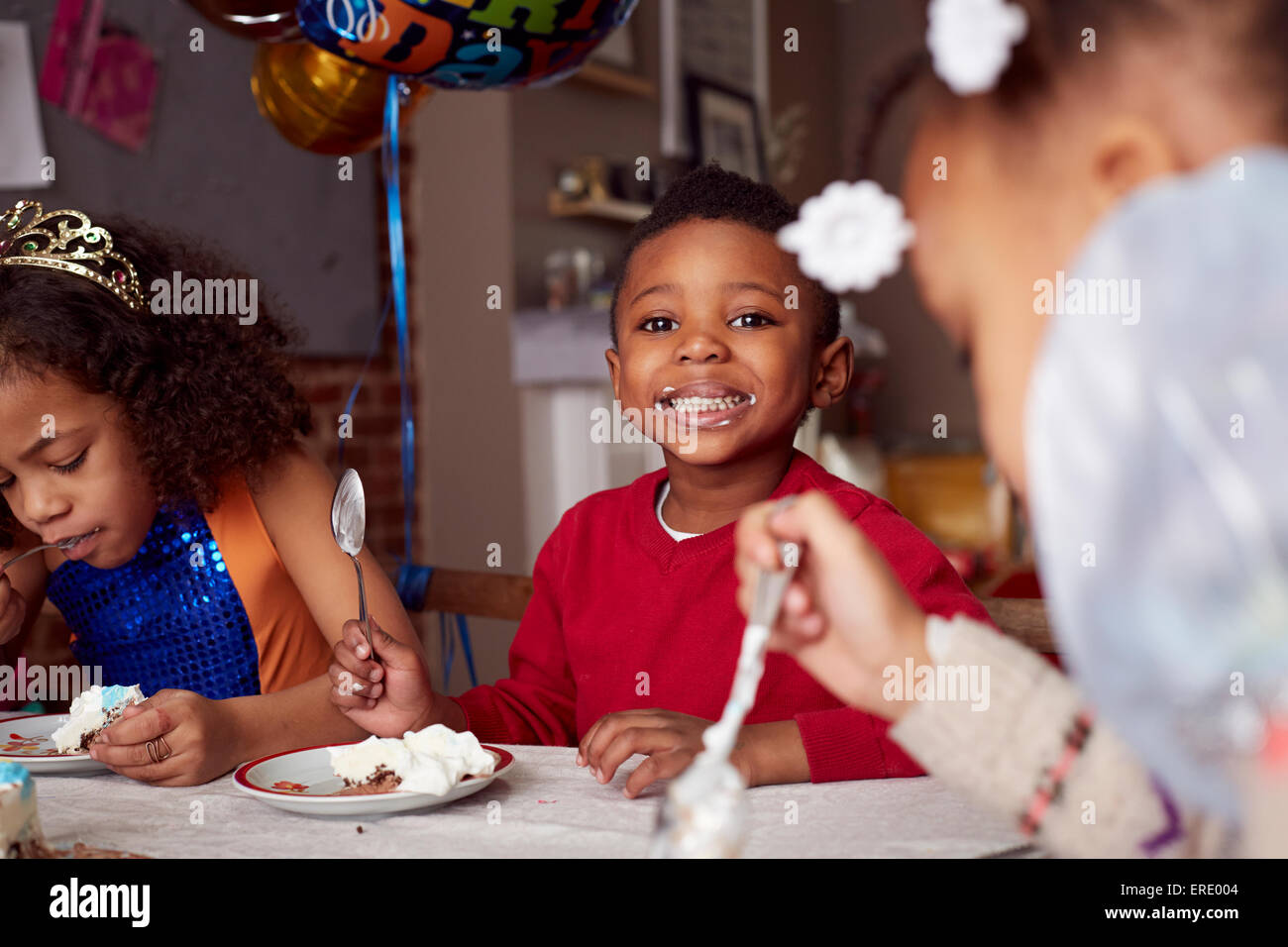 Children eating cake at party Stock Photo Alamy