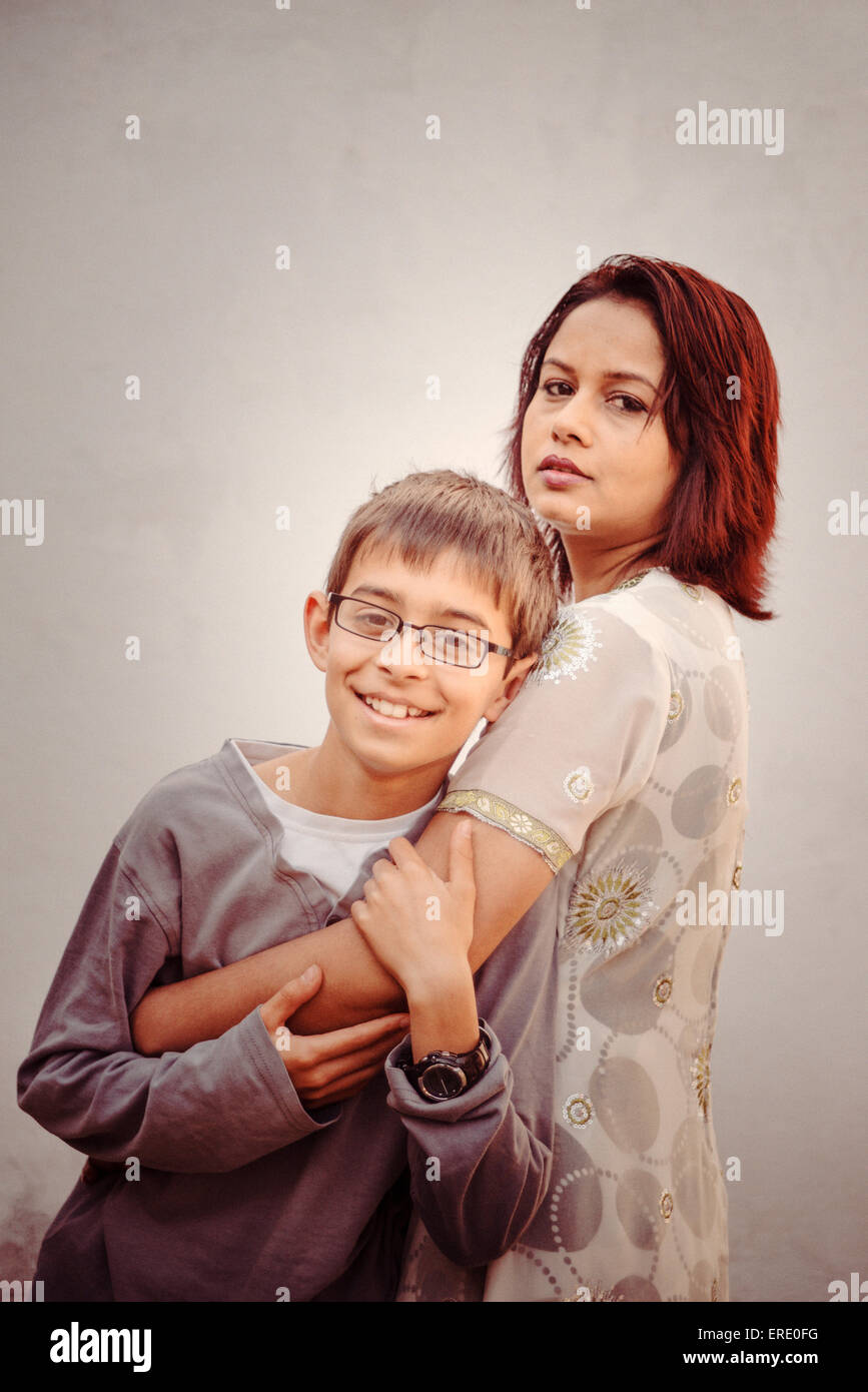 Mother and son hugging outdoors Stock Photo