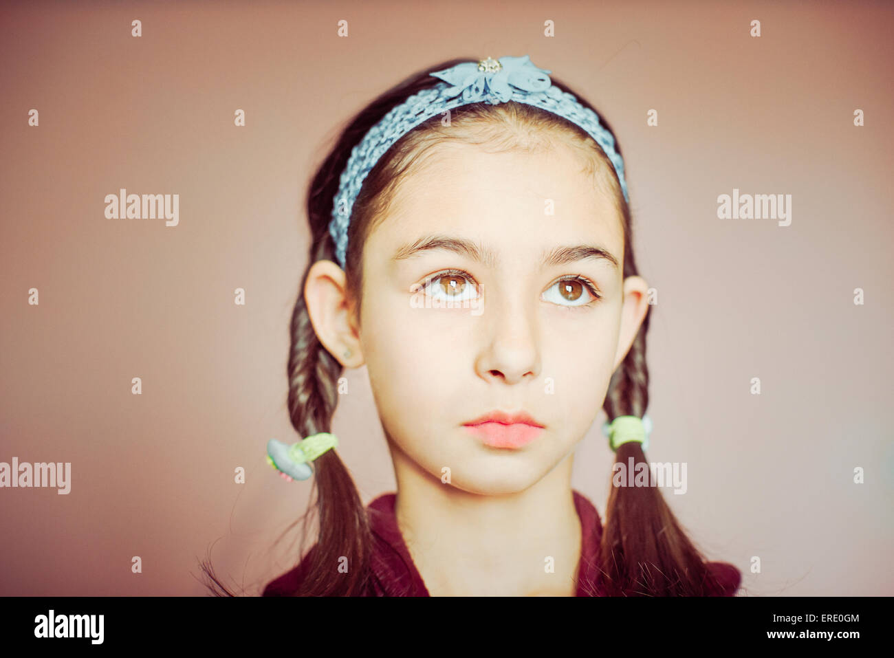 Mixed race girl wearing braid pigtails Stock Photo