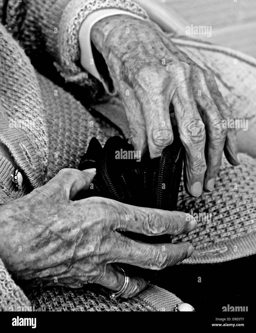 The aged and wrinkled hands of an old lady woman pensioner senior citizen Stock Photo