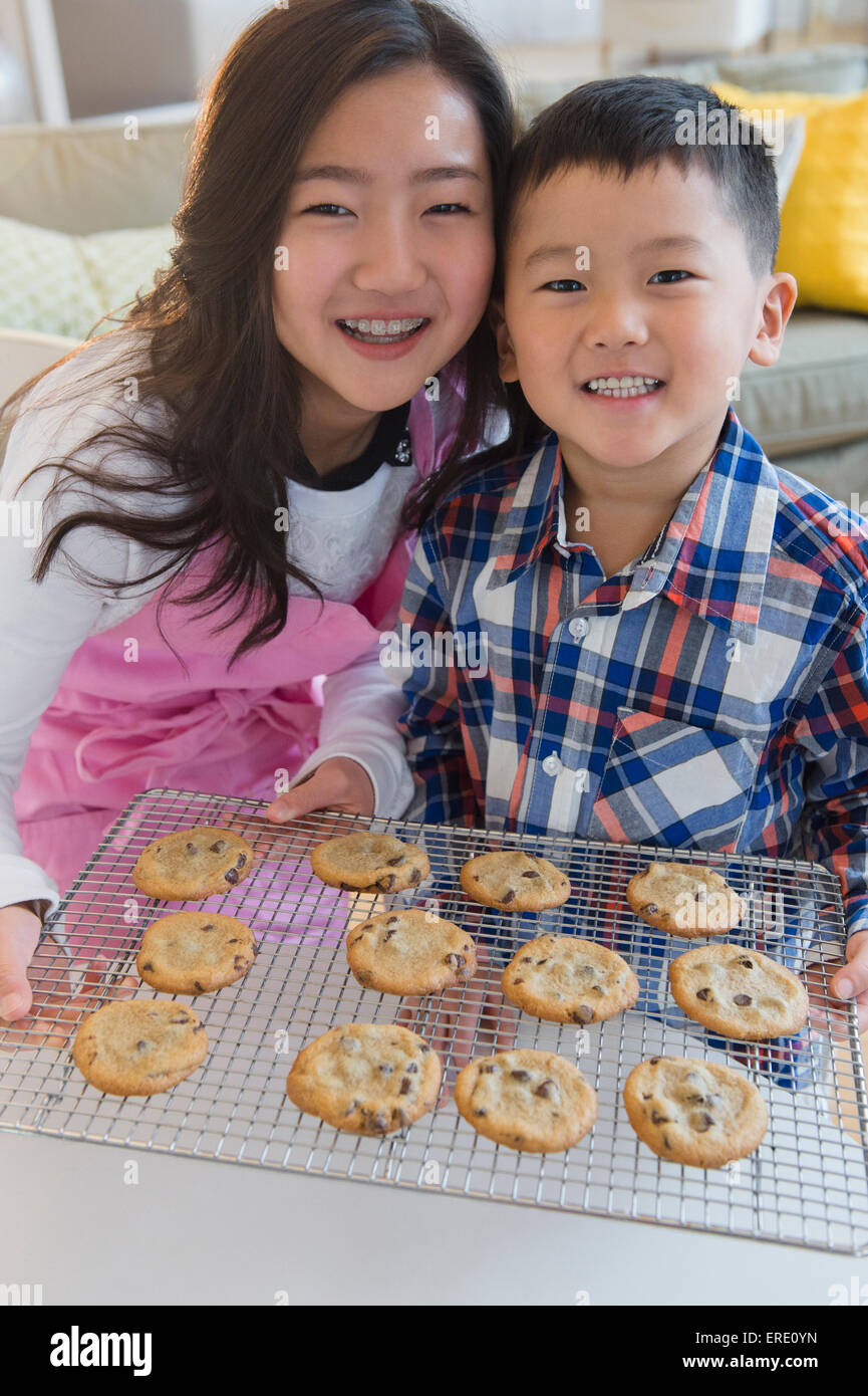 Asian brother and sister baking cookies Stock Photo
