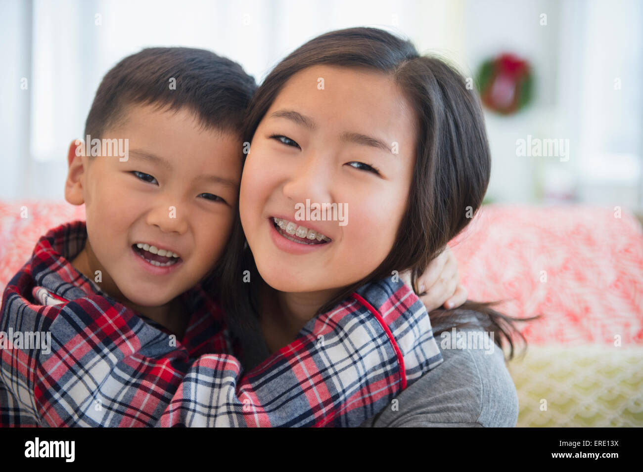 Asian brother and sister hugging Stock Photo