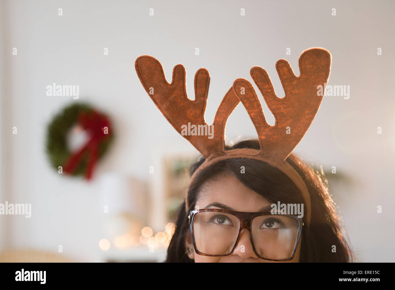 Pacific Islander woman wearing Christmas reindeer horns Stock Photo