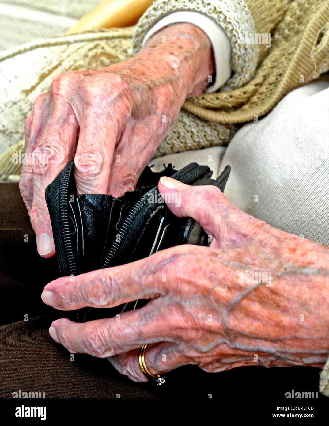 The aged and wrinkled hands of an old lady woman pensioner senior citizen Stock Photo