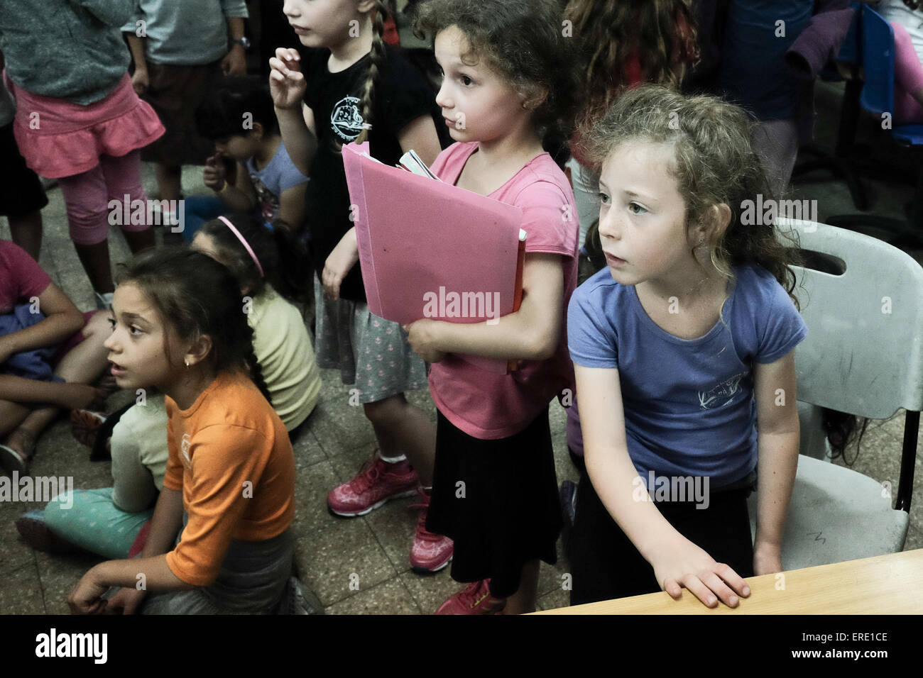 Jerusalem, Israel. 2nd June, 2015. Teachers verify full attendance as students of the Evelina De Rothchild Elementary School take cover in underground shelters as a nationwide siren goes off in the framework of the Home Front Command's week long 'Turning Point 15' exercise, drilling civilian defense. Credit:  Nir Alon/Alamy Live News Stock Photo