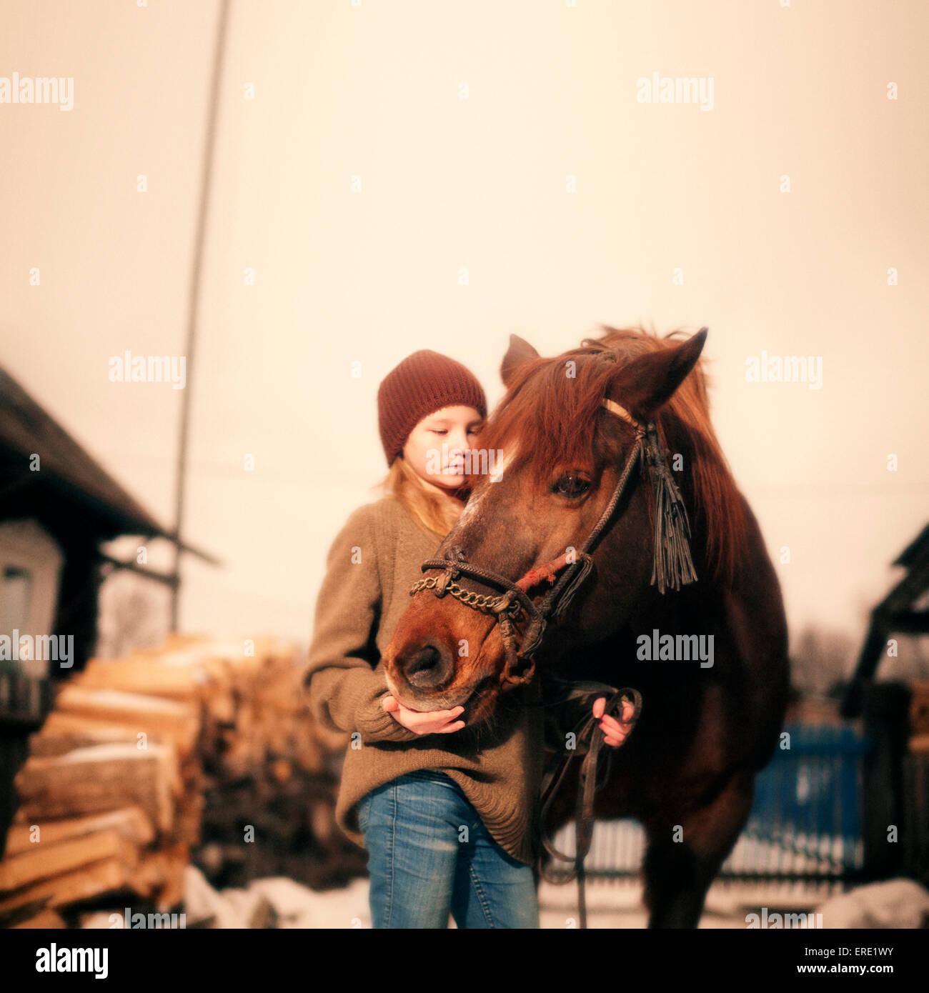 Caucasian girl holding rein of horse Stock Photo