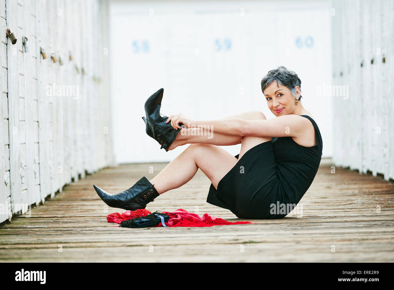 Woman taking off her boots hires stock photography and images Alamy