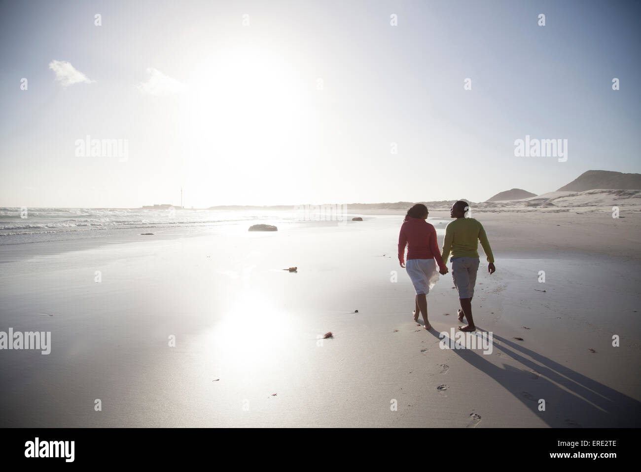Couple walking on beach Stock Photo