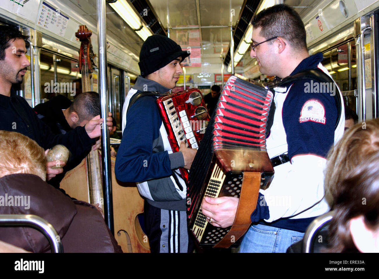 Group of busking musicians playing in a tube train in the Paris underground Stock Photo