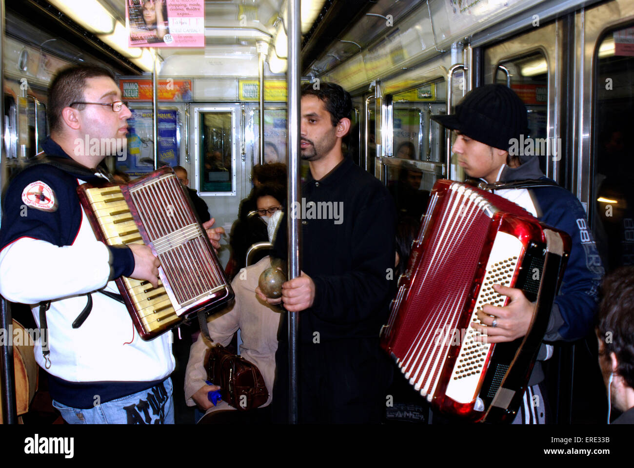 Group of busking musicians playing in a tube train in the Paris underground Stock Photo