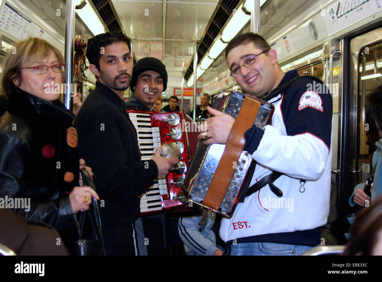 Group of busking musicians playing in a tube train in the Paris underground Stock Photo