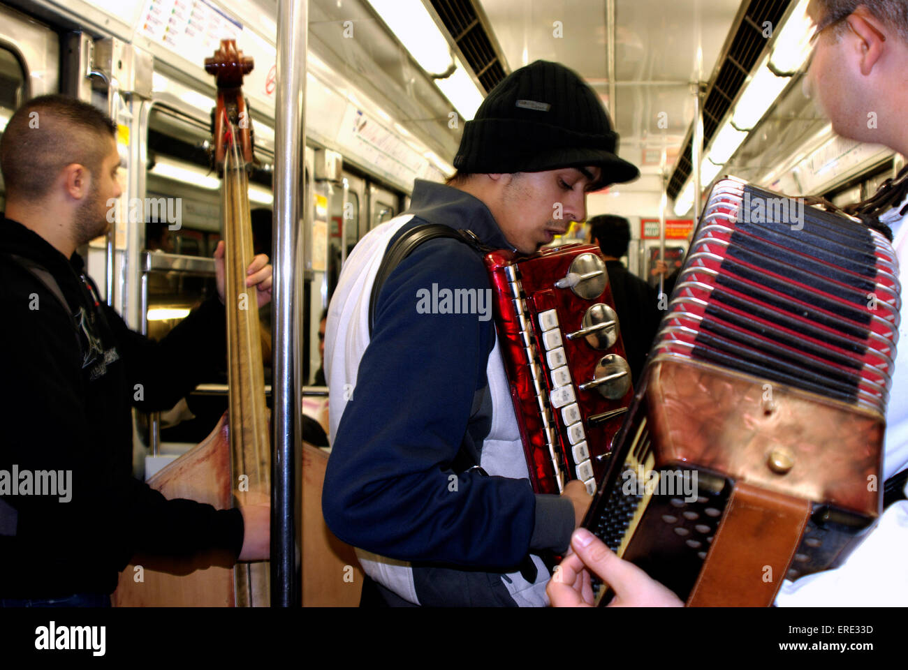 Group of busking musicians playing in a tube train in the Paris underground Stock Photo