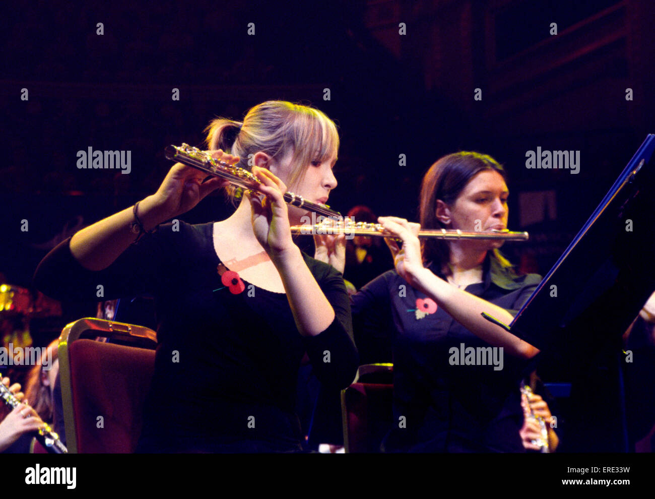 Two female flute players playing in a youth symphony orchestra at one of the Schools Prom series of concerts at the Royal Albert Hall, London Stock Photo