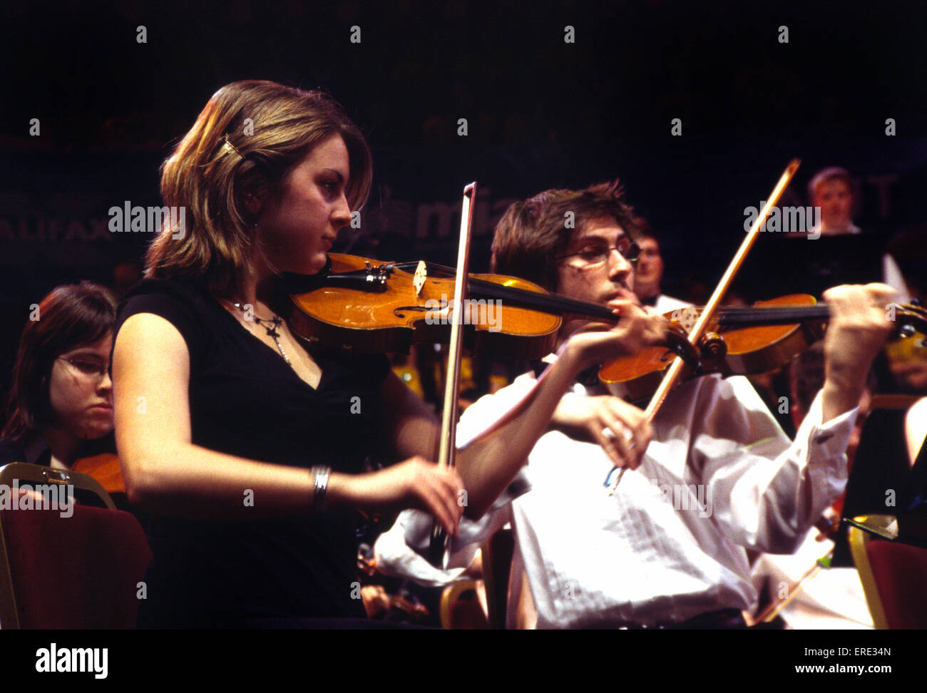 Violinists. Part of the violin section of a youth symphony orchestra, playing at the Royal Albert Hall, London as part of the Stock Photo