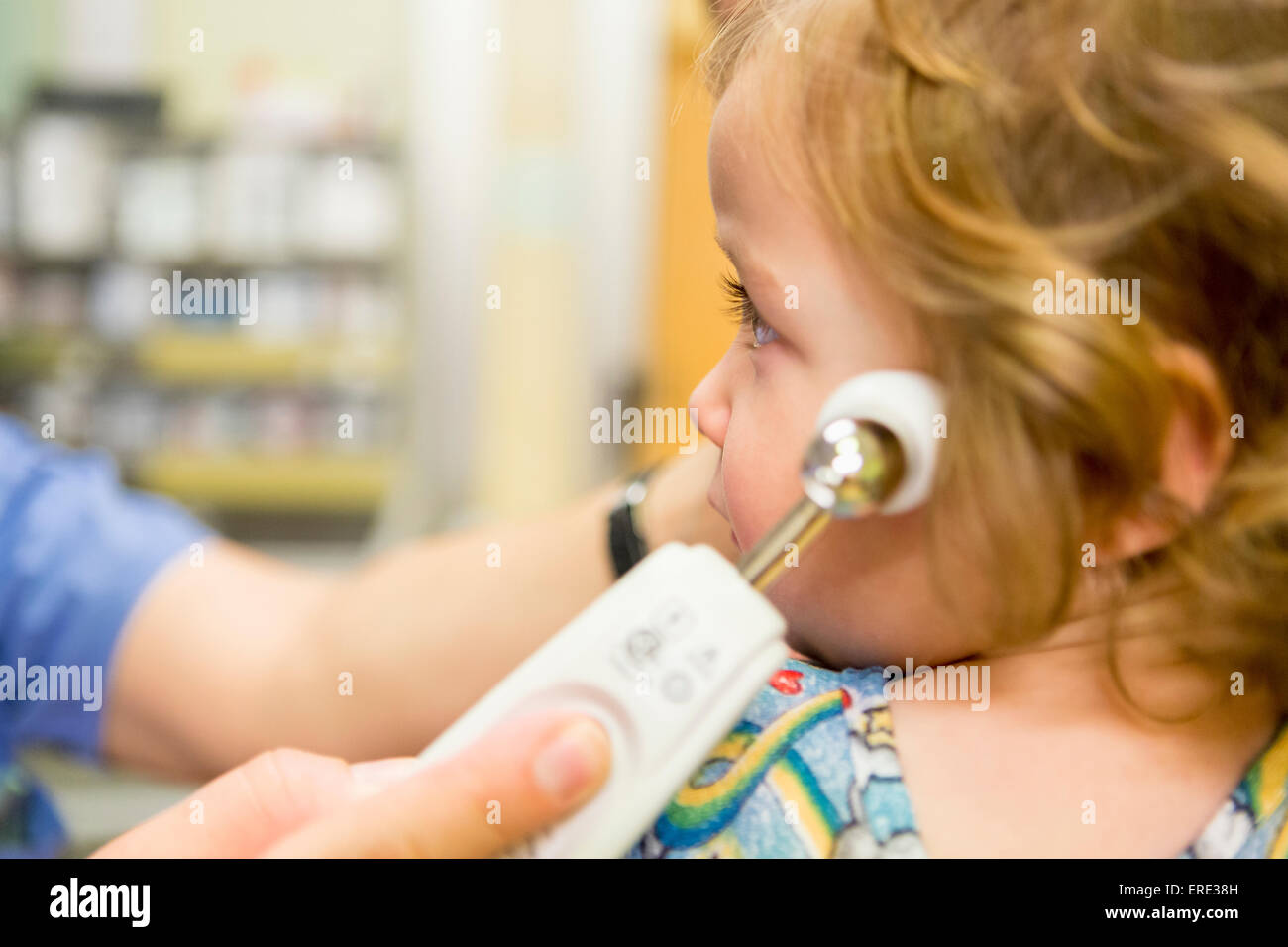 Close up of doctor taking temperature of boy with thermometer Stock Photo