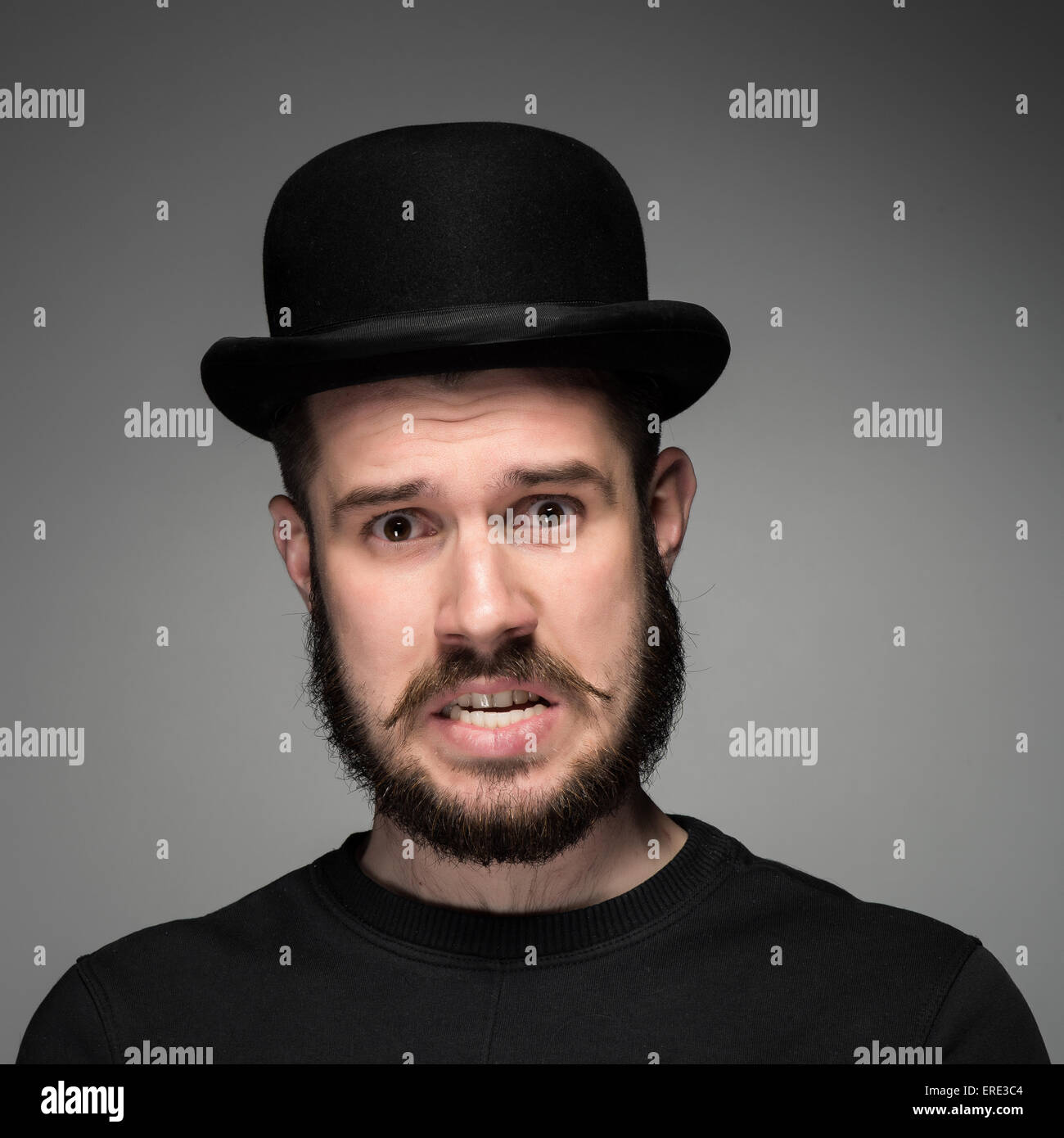 Portrait of young indignant man in studio Stock Photo Alamy