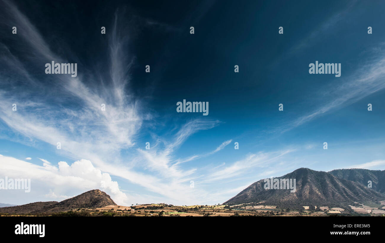 Cloudy blue sky over mountains in remote landscape Stock Photo - Alamy