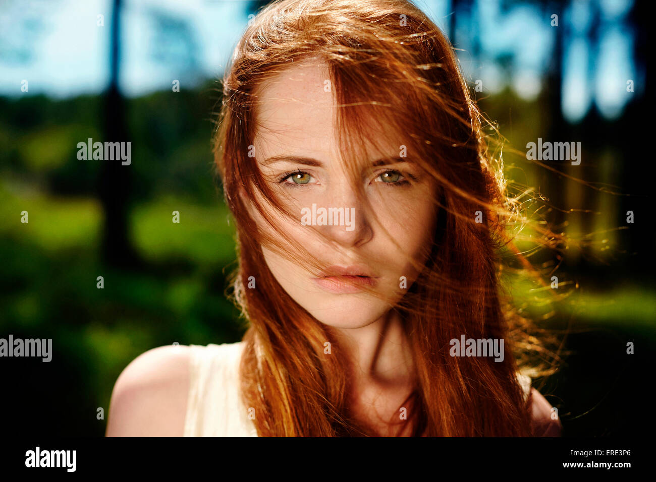 Caucasian woman with red hair in wind Stock Photo
