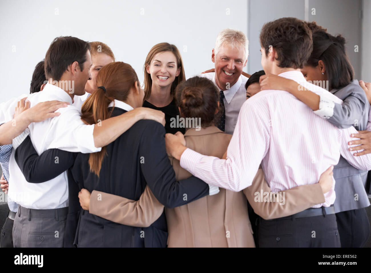 Group Of Businesspeople Bonding In Circle At Company Seminar Stock Photo