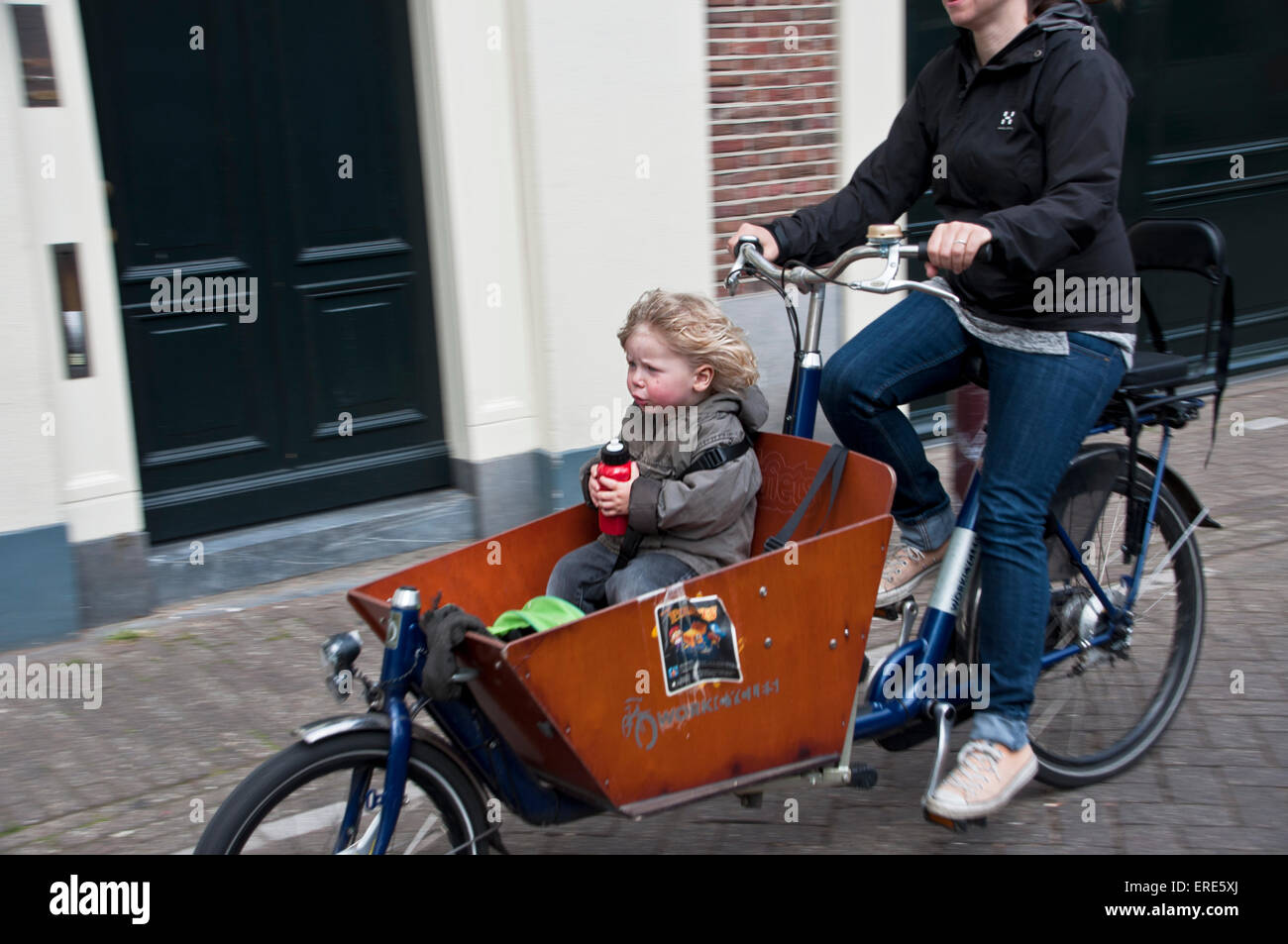 Child riding in box on the front of a bicycle in Amsterdam Stock Photo -  Alamy
