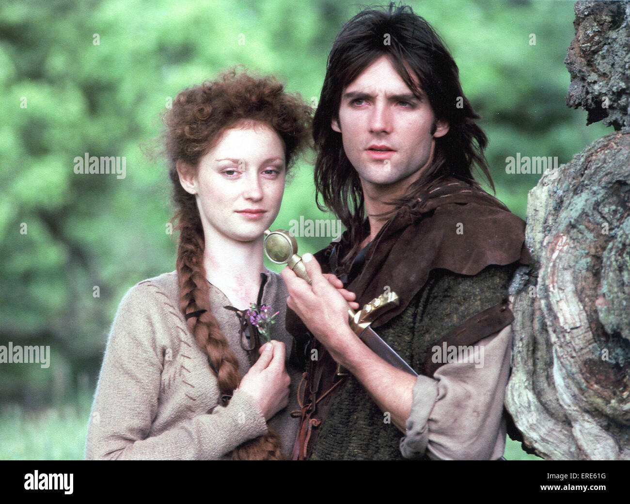 Actor Michael Praed as Robin Hood and ballerina Judi Trott as Maid Marion filming Robin of Sherwood in the Forest of Dean in Stock Photo