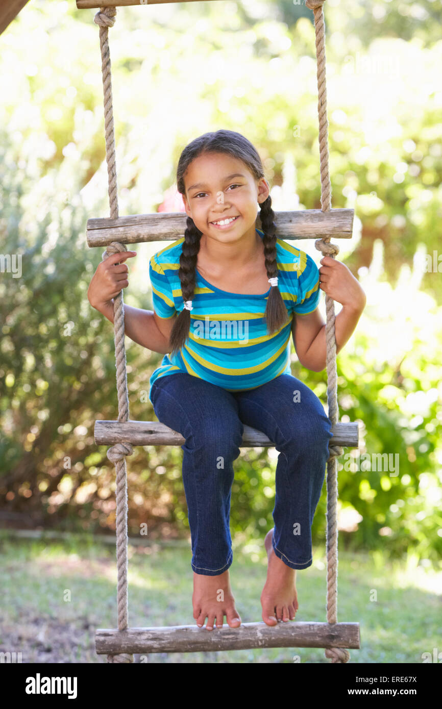 Young Girl Climbing Rope Ladder To Treehouse Stock Photo Alamy