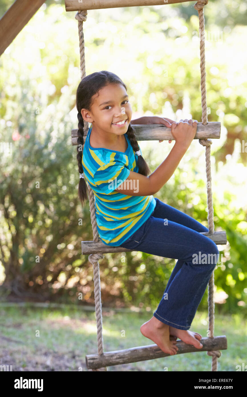 Young Girl Climbing Rope Ladder To Treehouse Stock Photo Alamy