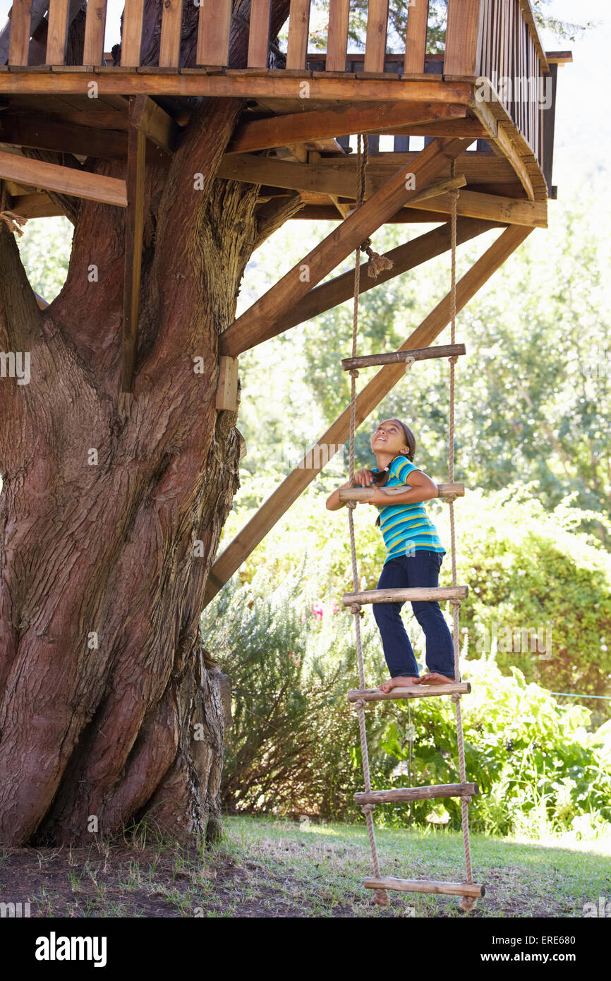 Young Girl Climbing Rope Ladder To Treehouse Stock Photo Alamy