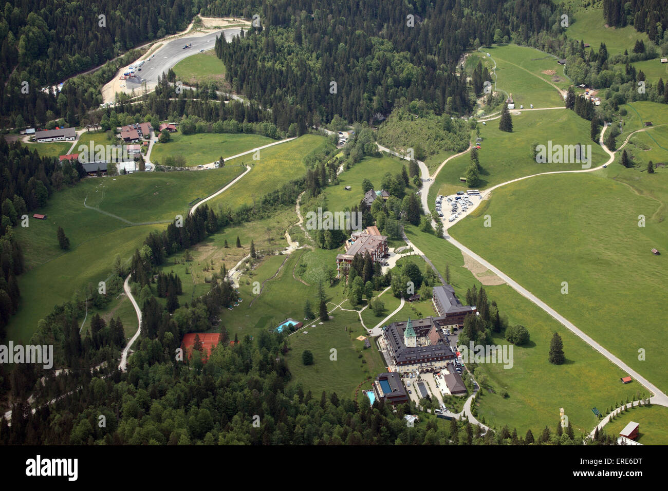 An aerial view shows the site of Schloss Elmau near Garmisch-Partenkirchen. The hotel facilities can be seen to the right in the foreground. In the center is the new construction with luxury suites where the top politicians will sleep and meet for conferences. The hotel is providing around 150 rooms and suites. In the background to the left is the new helicopter landing pad. State and government leaders from the G7 countries are meeting here on 07 and 08 June. Photo: LUFTBILD BERTRAM/dpa Stock Photo
