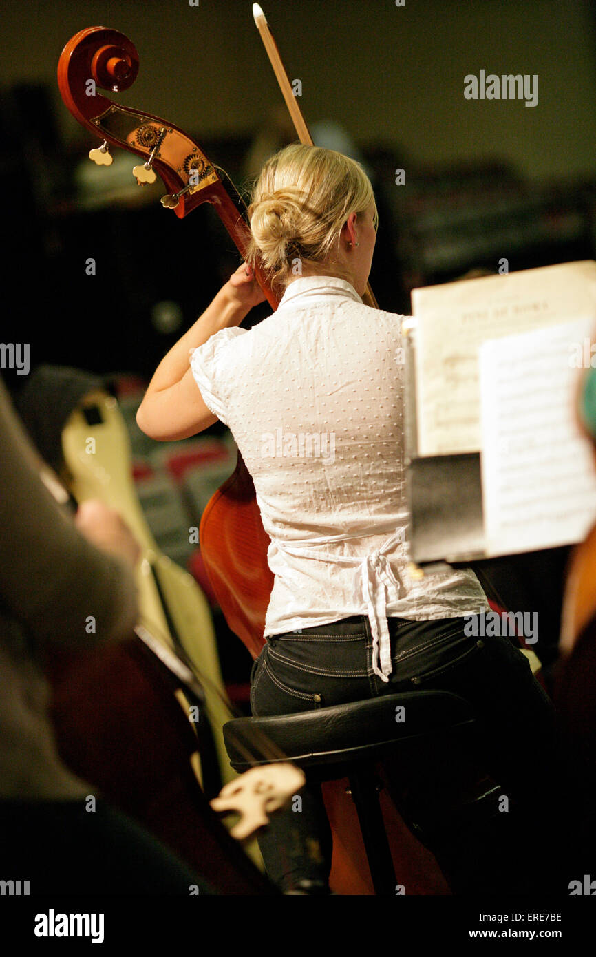 Female double bass player in a rehearsal. Stock Photo