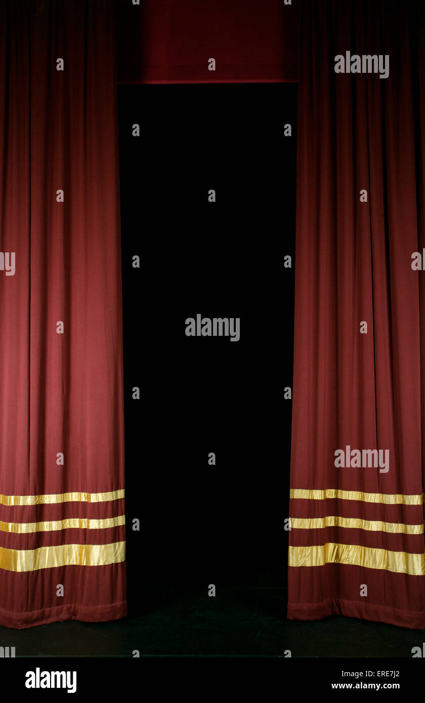 Red stage curtains with gold stripes, partly open Stock Photo