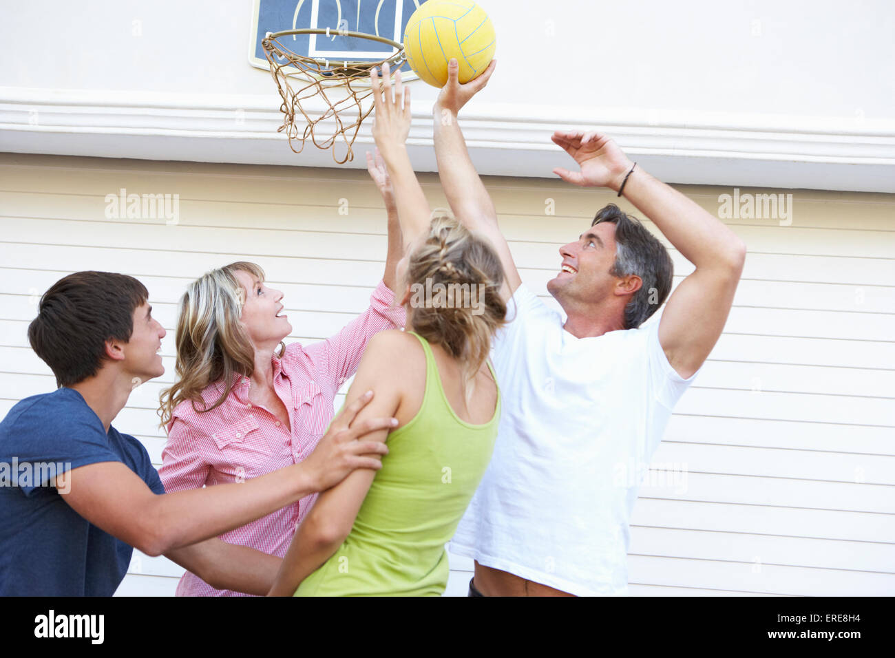 Teenage Family Playing Basketball Outside Garage Stock Photo - Alamy