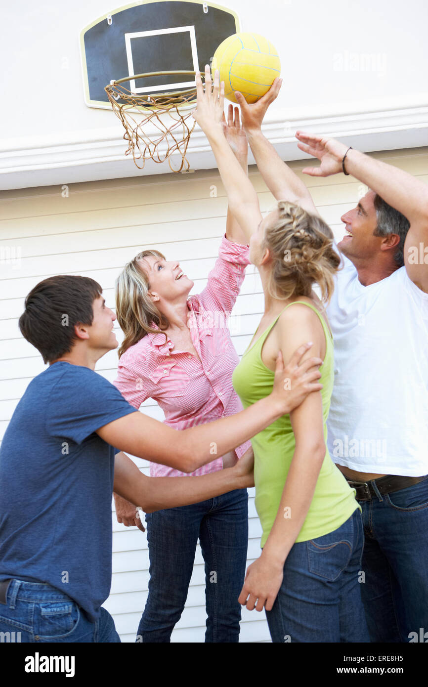 Teenage Family Playing Basketball Outside Garage Stock Photo - Alamy