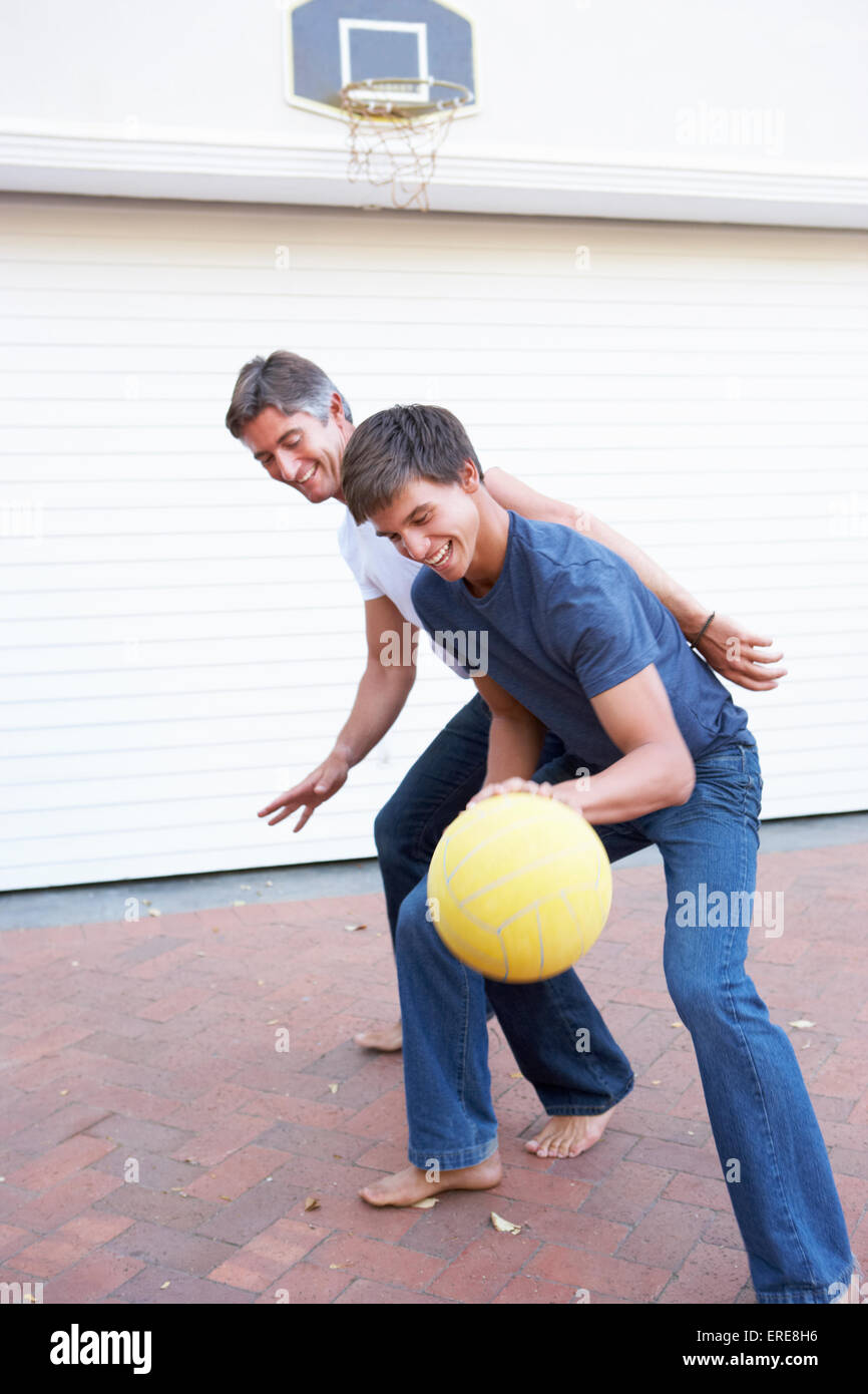 Father And Teenage Son Family Playing Basketball Outside Garage Stock ...