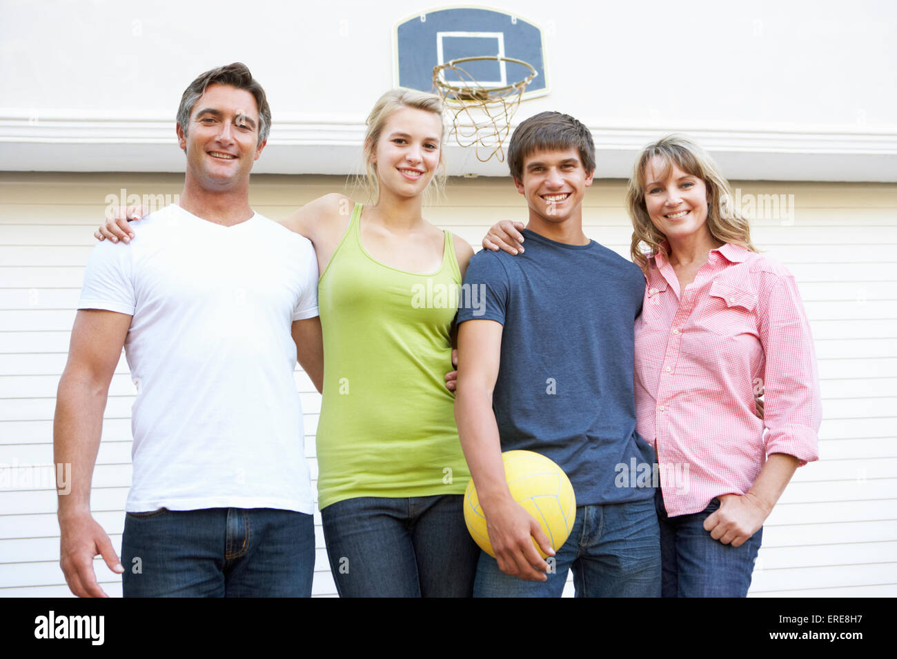 Portrait Of Teenage Family Playing Basketball Outside Garage Stock ...