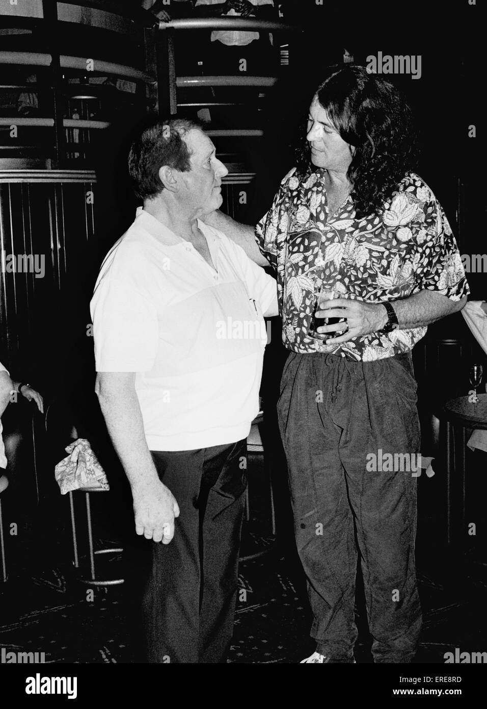 Jim Marshall, OBE (left, b. 1923), founder of Marshall Amplification, is pictured talking with Ian Gillan (b. 1945), singer with the band Deep Purple, at a private function in London in 1988. Jim is known as 'The Father of Loud'. Stock Photo