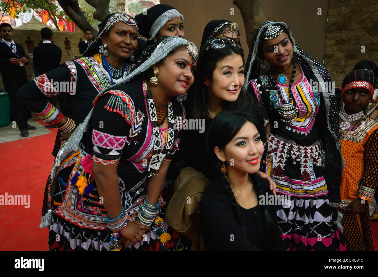 The Uzbek women with a selfie stick taking selfies with Rahasthani folk dance troupe Surajkund Haryan 1st Feb 2015 Stock Photo