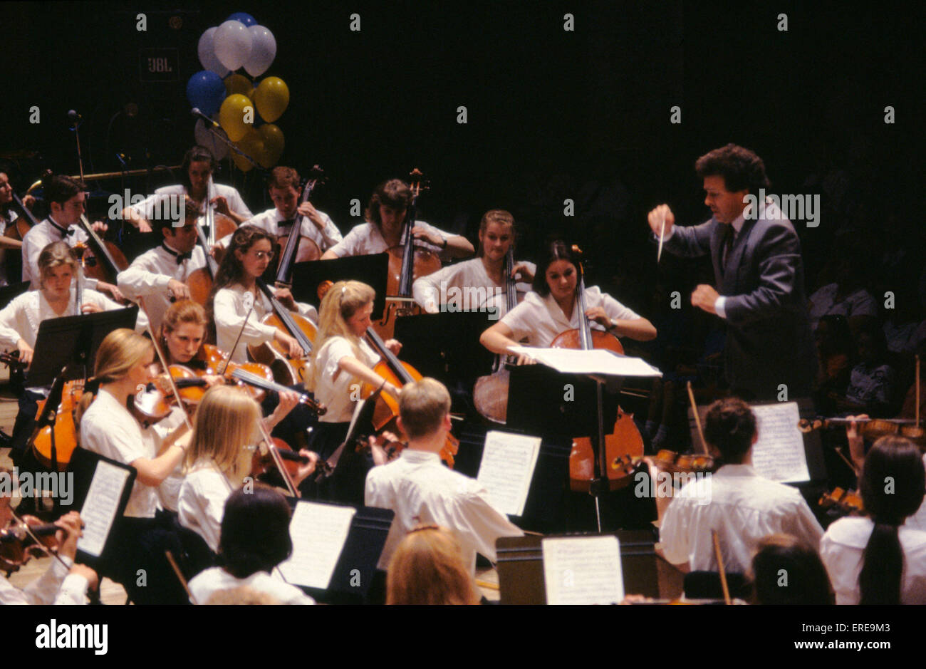 Youth Orchestra playing in concert 'cello section with conductor. Stock Photo