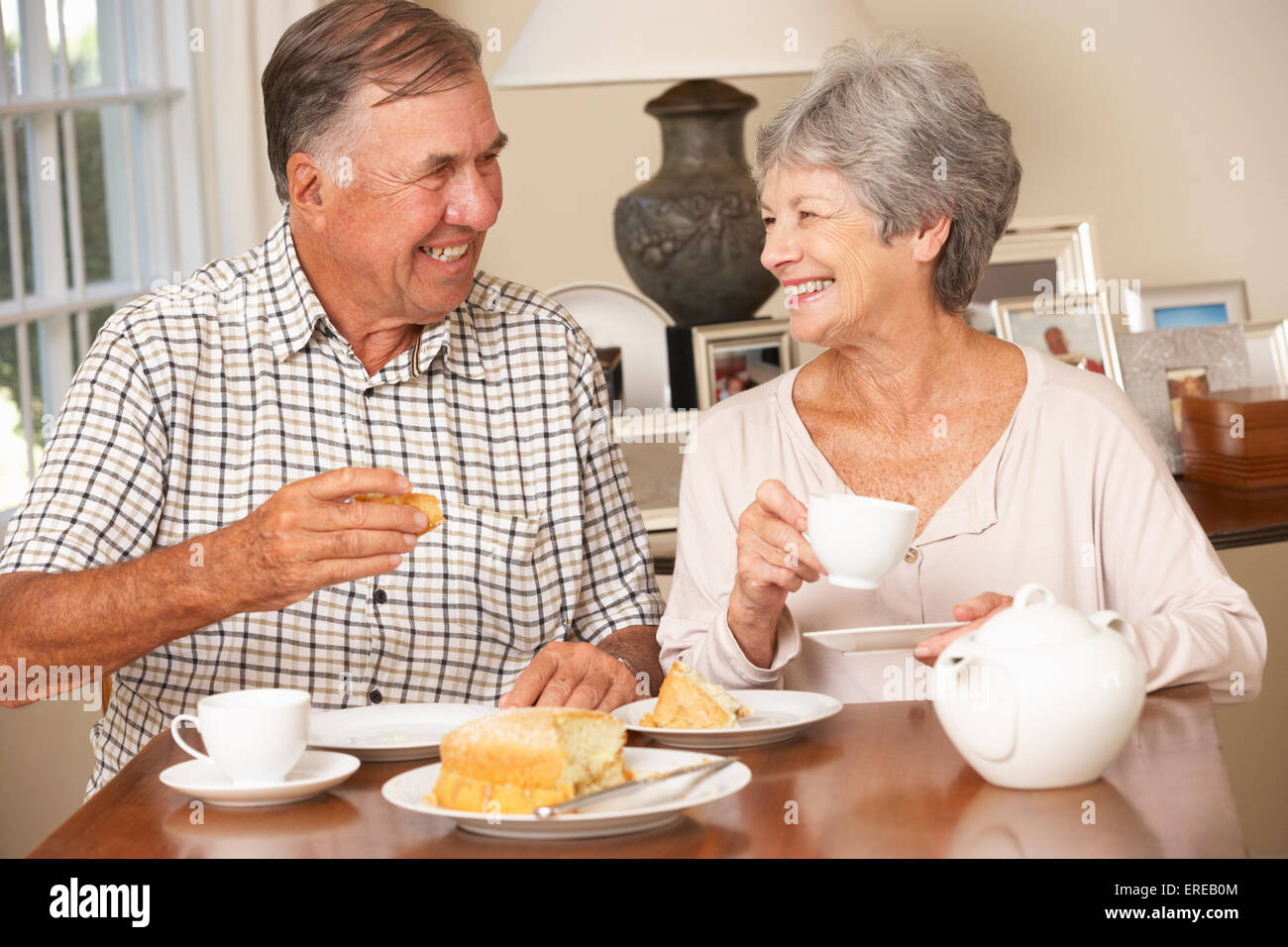Retired Senior Couple Enjoying Afternoon Tea Together At Home Stock Photo