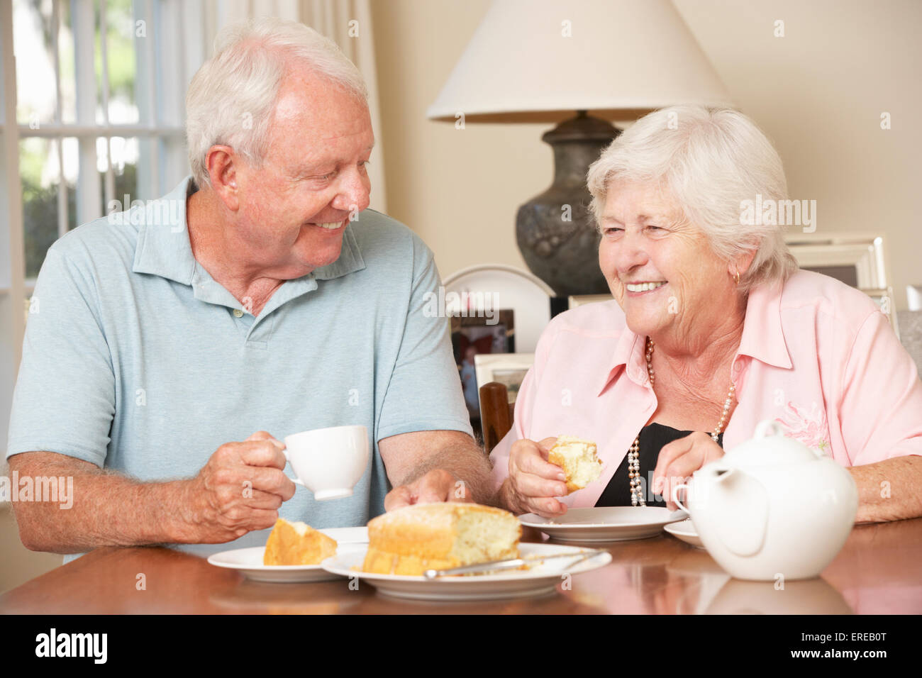 Retired Senior Couple Enjoying Afternoon Tea Together At Home Stock Photo