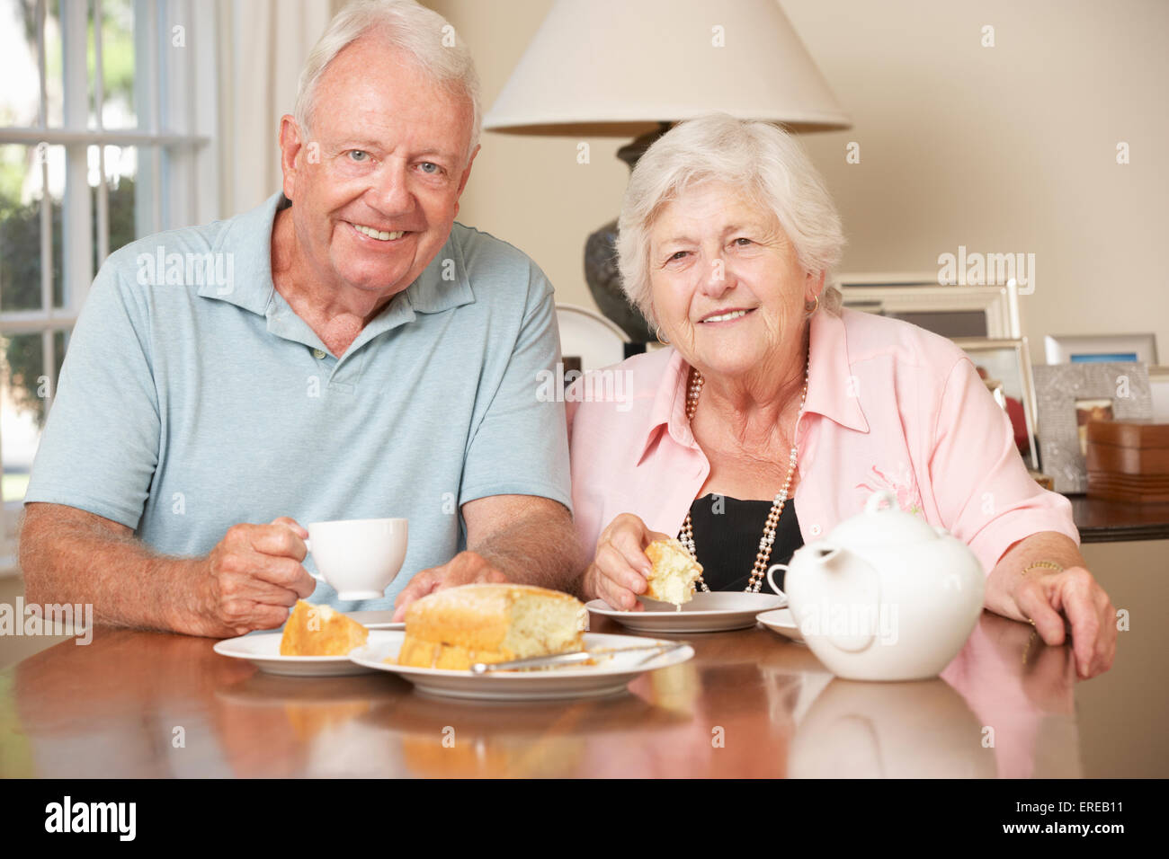 Retired Senior Couple Enjoying Afternoon Tea Together At Home Stock Photo