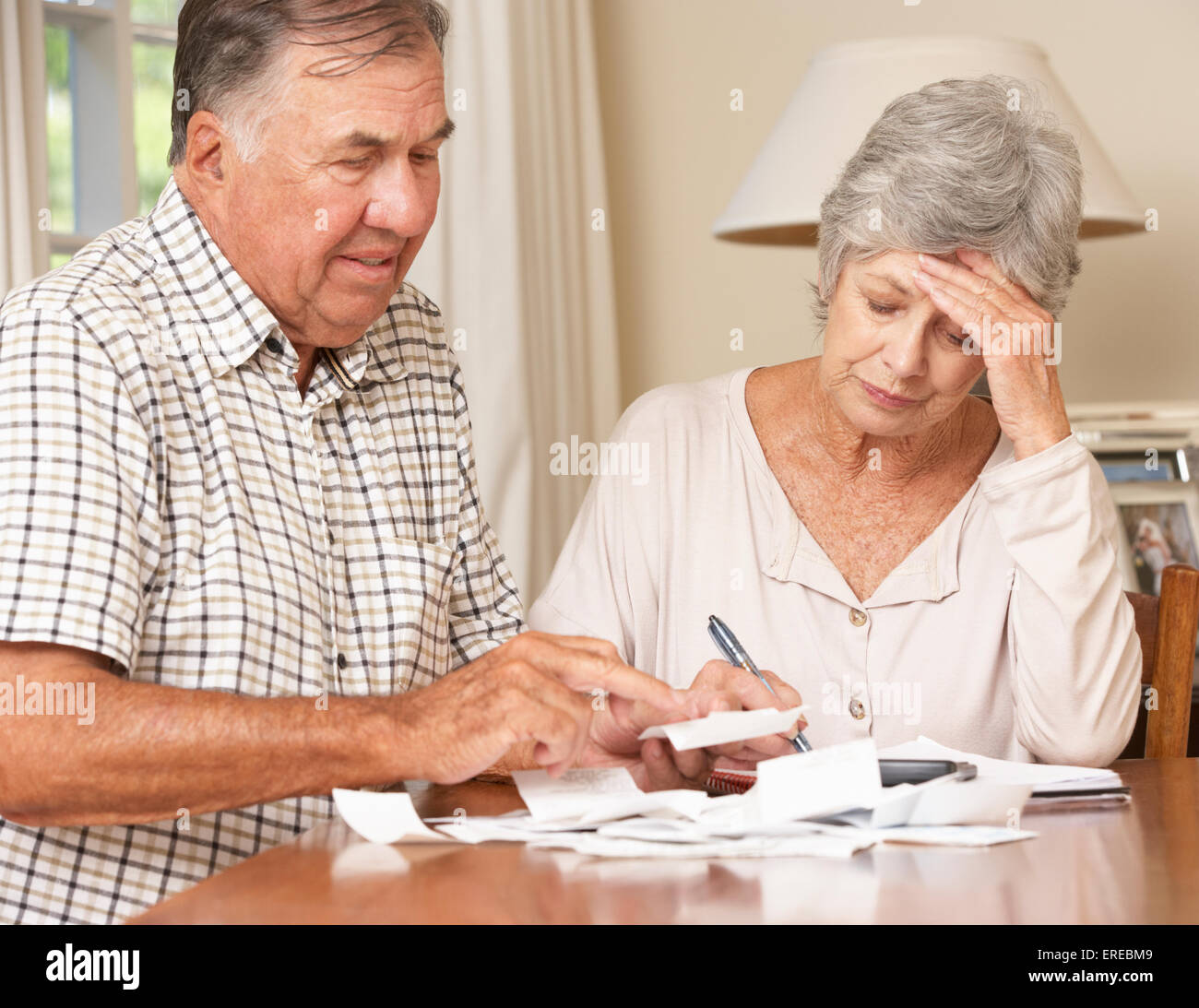 Senior Couple Concerned About Debt Going Through Bills Together Stock Photo