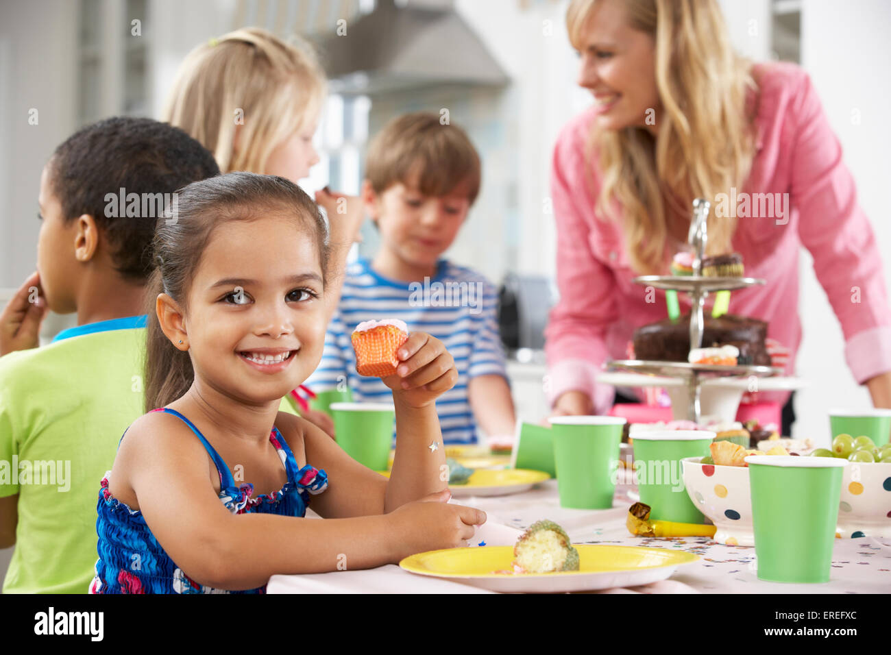 Group Of Children Enjoying Birthday Party Food At Table Stock Photo - Alamy