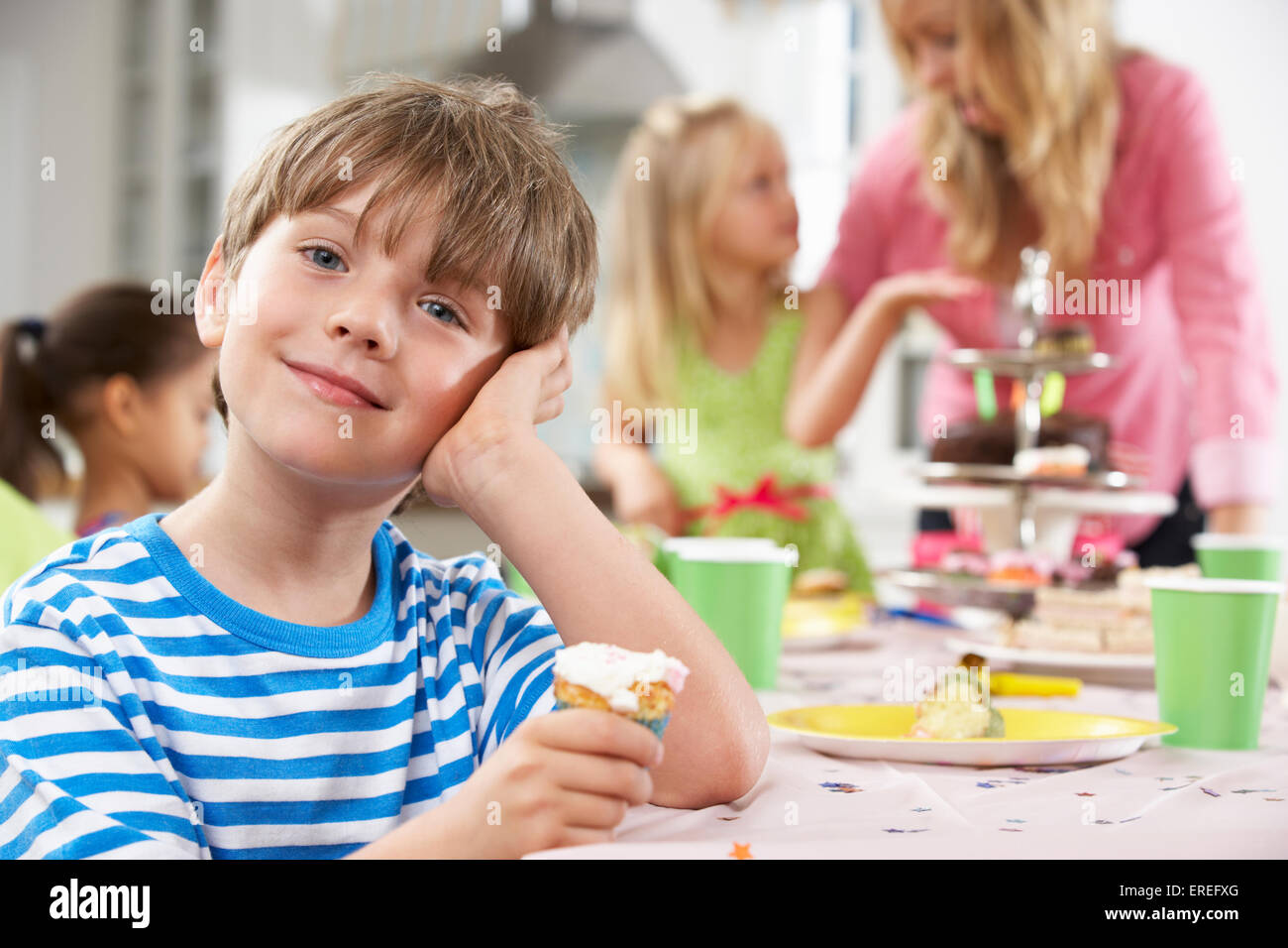Group Of Children Enjoying Birthday Party Food At Table Stock Photo - Alamy